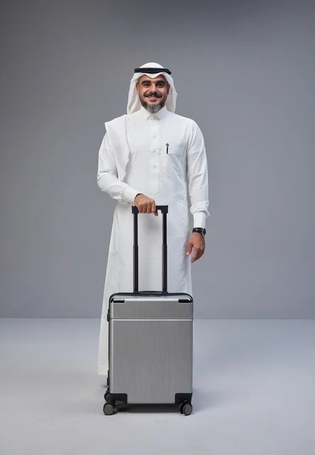 رجل سعودي بالزي التقليدي مع حقيبة سفر