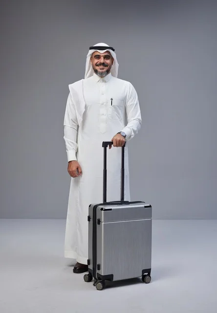 Saudi Man in Traditional Dress with Travel Suitcase