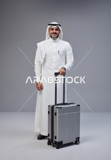 Saudi Man in Traditional Thobe with Silver Suitcase