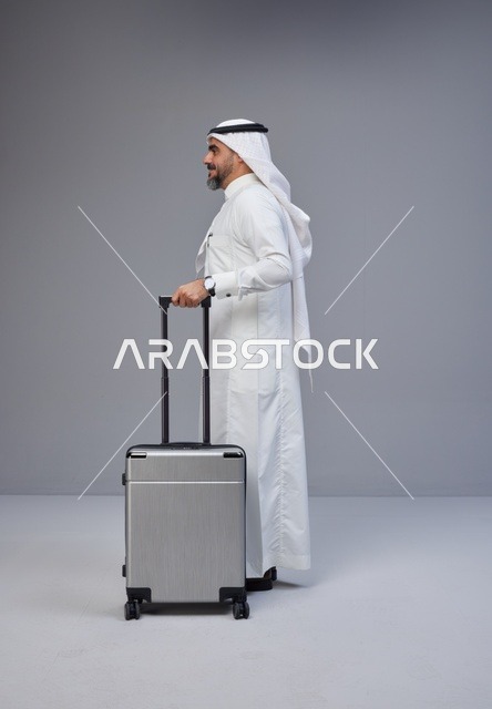 Saudi Man in Traditional Thobe with Silver Suitcase