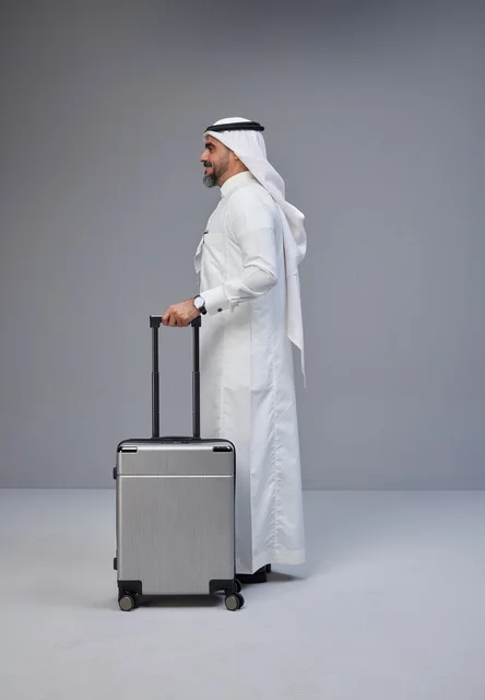 Saudi Man in Traditional Thobe with Suitcase