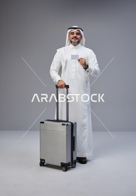 Saudi Man with Suitcase and Card in Studio