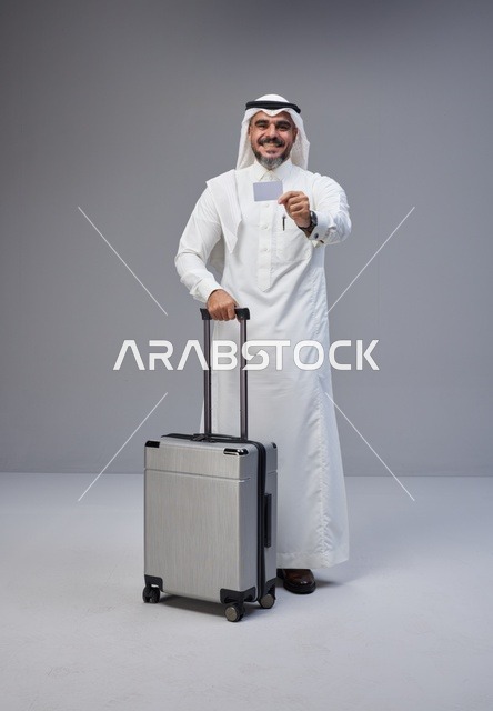 Saudi Man with Suitcase Holding Credit Card