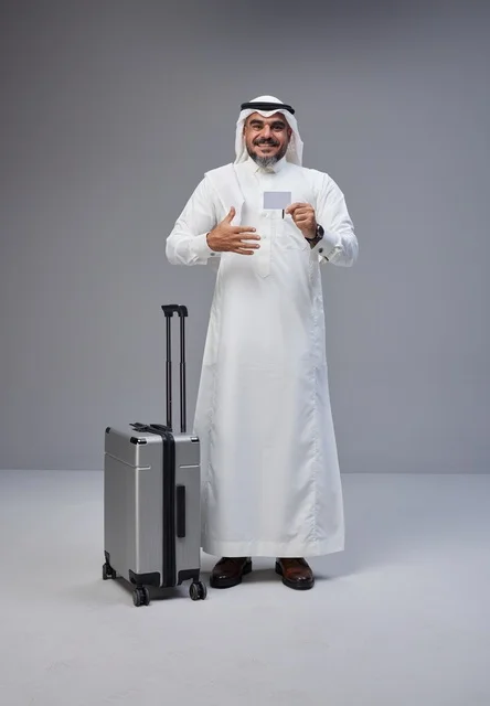 Saudi man in traditional attire holding card with suitcase