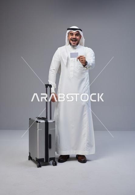 Saudi Man with Suitcase Holding Credit Card in Studio
