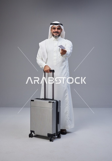 Saudi Man with Suitcase Holding Credit Card