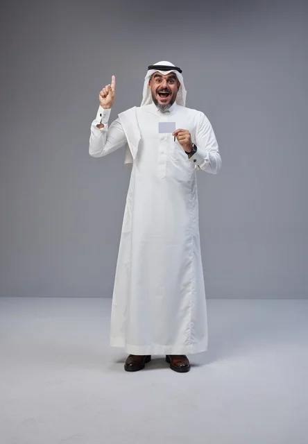 Saudi man in traditional attire holding blank identification card
