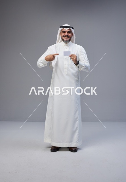 Saudi Man Holding Blank Card in Traditional Dress