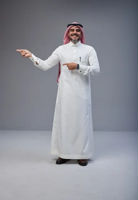 Saudi Man in Traditional Thobe Pointing in Studio