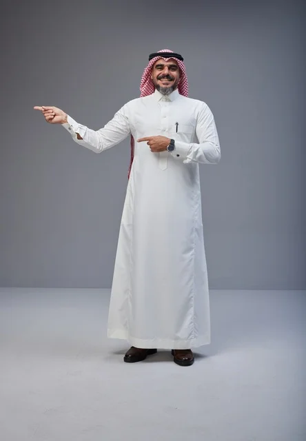 Smiling Saudi Man Pointing in Traditional Dress