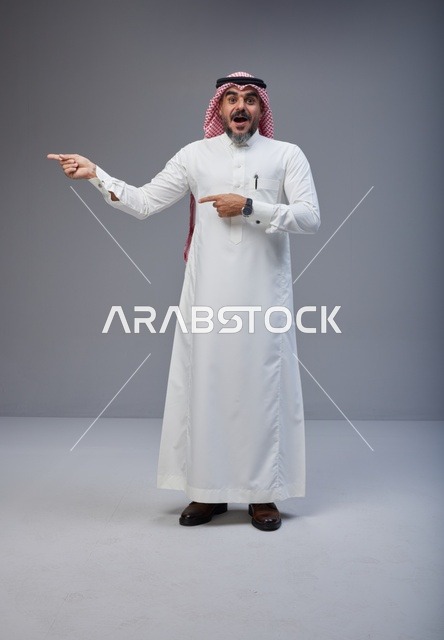 Saudi Man in Traditional Thobe Pointing with Surprised Face