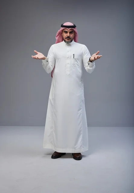Saudi Man in Traditional Thobe Making a Hand Gesture