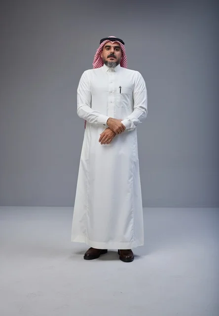 Saudi Man in Traditional White Thobe on Grey Background