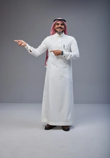 Saudi Man in Traditional Thobe Pointing in Studio