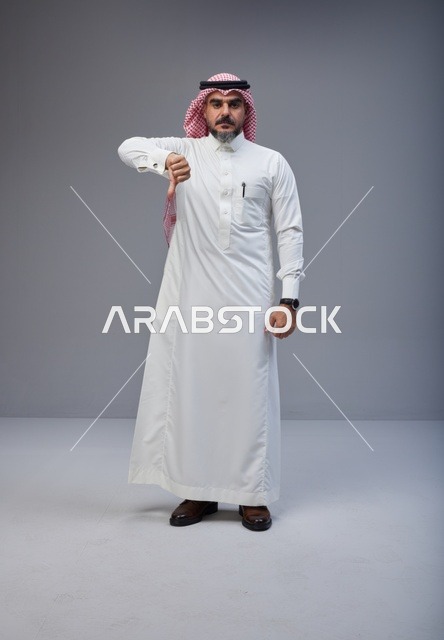 رجل سعودي بالزي التقليدي يشير بعلامة الرفض