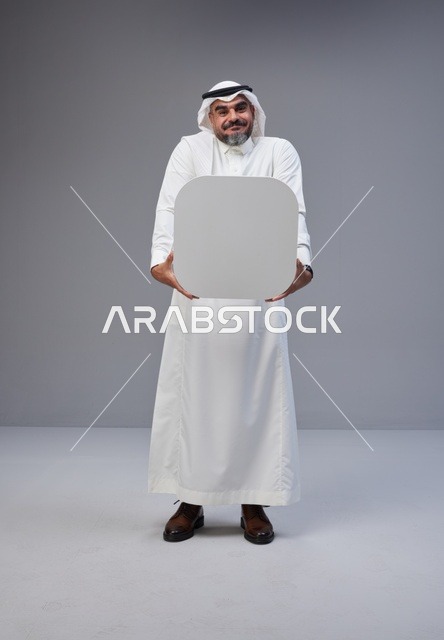 Saudi Man in Traditional Thobe Holding Blank Sign