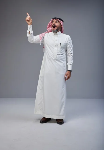 Surprised Saudi Man Pointing Up in Traditional Dress