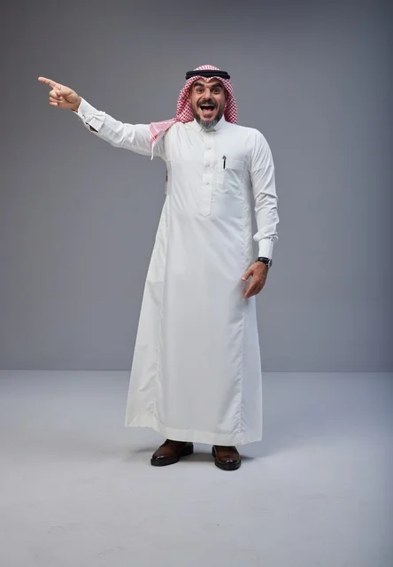 Saudi Man in Traditional Thobe Pointing in Studio