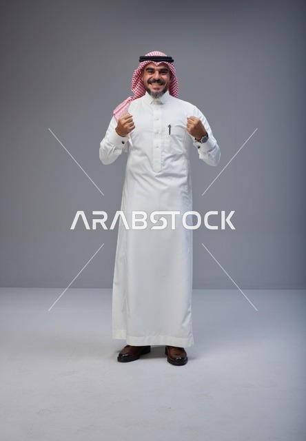 Saudi Man in Traditional Thobe Celebrating Success