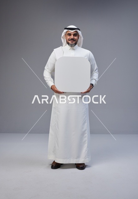 Saudi Man Holding Blank Rounded Board in Studio