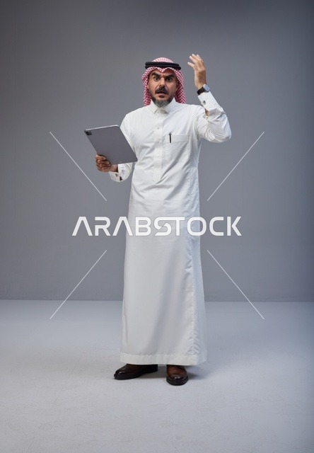 Saudi Man with Tablet Shocked Expression in Studio