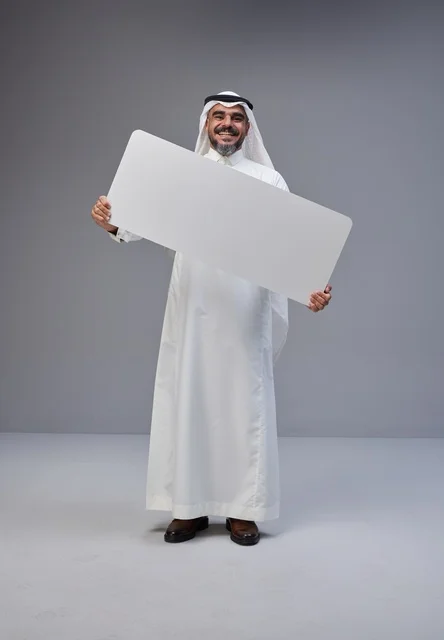 Saudi Man in Traditional Dress Holding Blank Sign