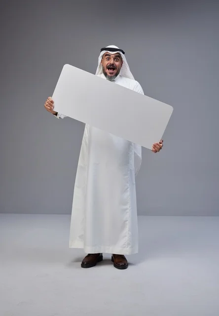 Saudi Man in Traditional Dress Holding Blank Banner