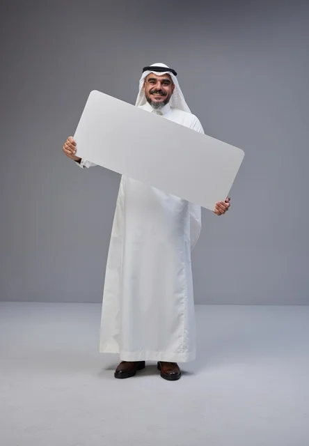 Saudi Man in Traditional Thobe Holding White Blank Board