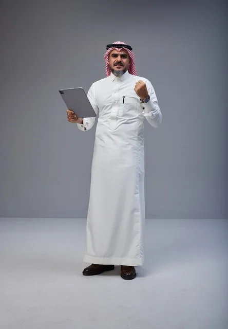 Saudi Man with Tablet Celebrating Success in Studio