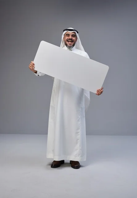 Saudi Man in Traditional Dress Holding Blank Banner