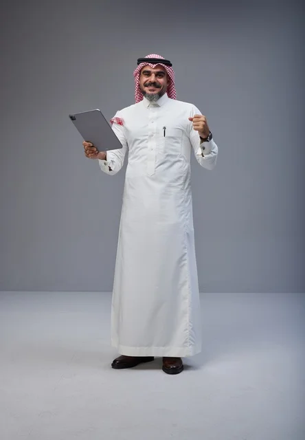 Saudi Man with Tablet Celebrating Success in Studio