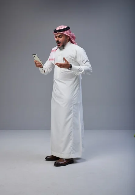 Saudi Man with Smartphone Shocked Expression Studio