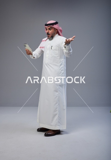 Surprised Saudi Man Using Smartphone in Studio