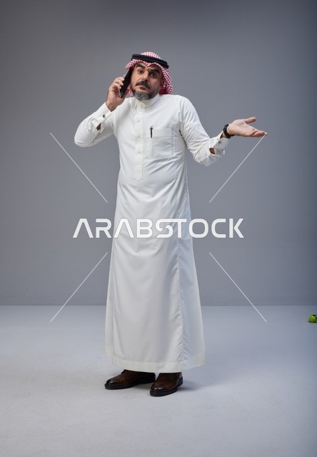 Saudi Man in Traditional Thobe Talking on Phone Studio
