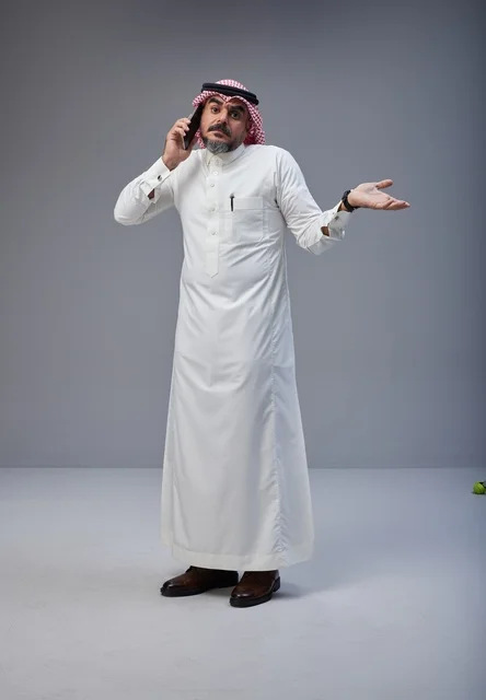 Saudi Man in Traditional Thobe Talking on Phone Studio