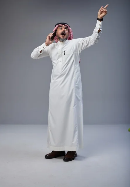 Surprised Saudi Man Talking on Mobile Phone in Studio