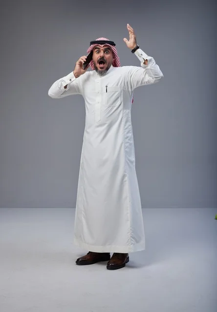 Shocked Saudi Man in Traditional Dress on Phone