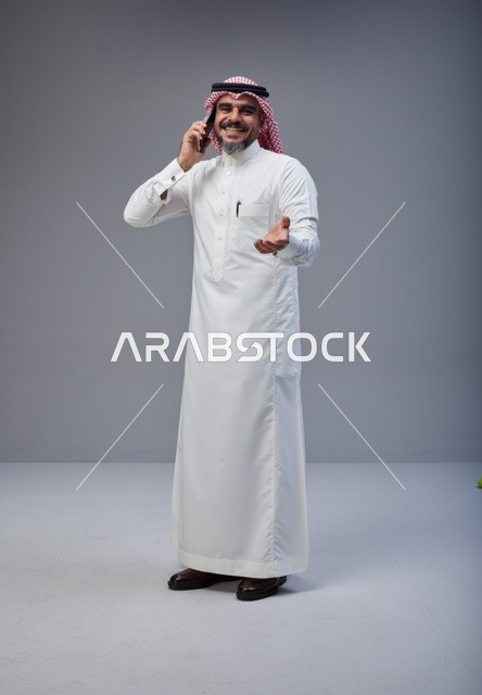 Saudi Man in Traditional Thobe Talking on Phone Studio