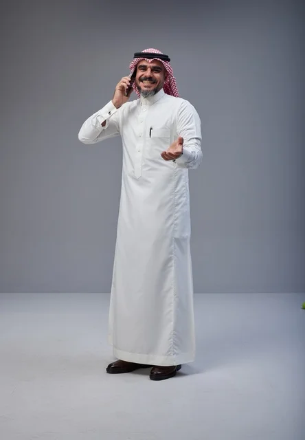 Saudi Man in Traditional Thobe Talking on Phone Studio
