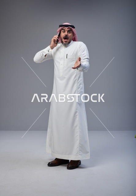 Shocked Saudi Man Using Smartphone in Studio