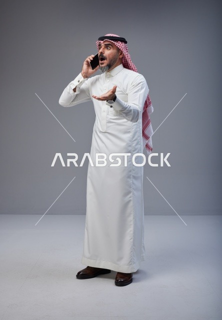 Surprised Saudi Man Talking on Smartphone in Studio