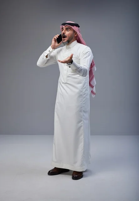 Surprised Saudi Man Talking on Smartphone in Studio