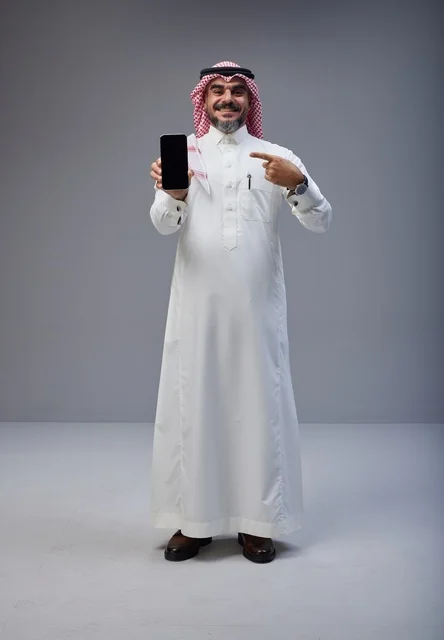 Saudi Man Holding Blank Smartphone Screen in Studio