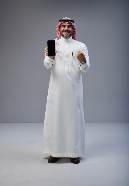 Saudi Man with Smartphone Success Gesture Studio