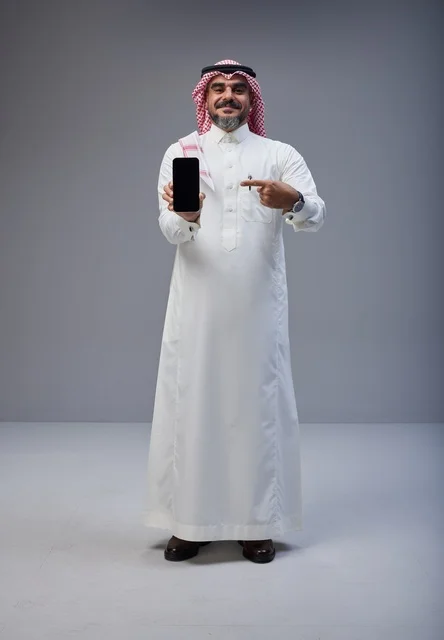 Saudi Man in Traditional Dress Holding Smartphone