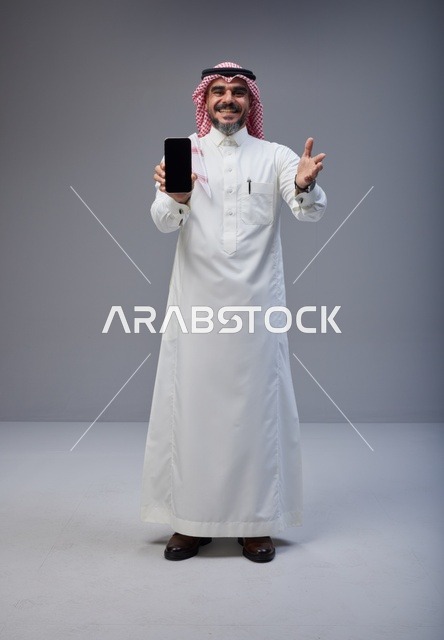 Saudi Man Holding Smartphone with Blank Screen