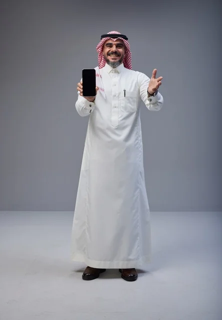 Saudi Man Holding Smartphone with Blank Screen