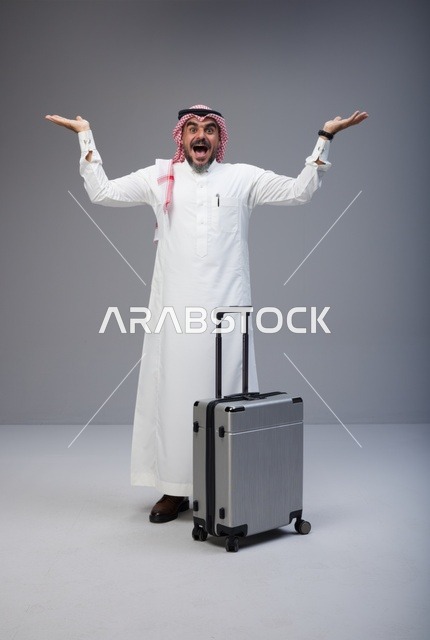 Excited Saudi Man with Suitcase in Studio