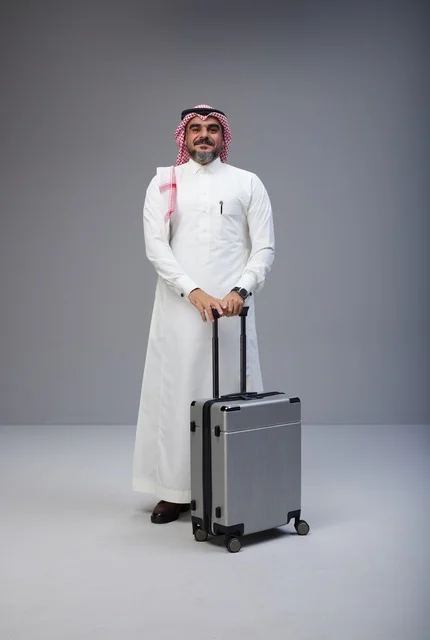رجل سعودي بالزي التقليدي مع حقيبة سفر