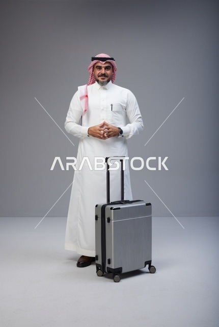 Saudi Man in Traditional Thobe with Suitcase